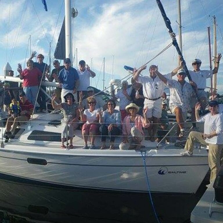 Friends and family posing for a photo on a sailboat