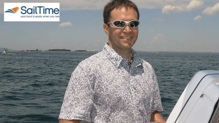 SailTime Franchisee posing at the helm