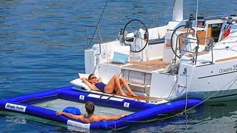 Woman laying out on the back of a Beneteau Oceanis 35.1