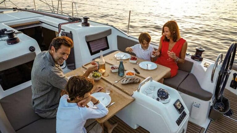 Family eating dinner aboard a Jeanneau Sun Odyssey 410