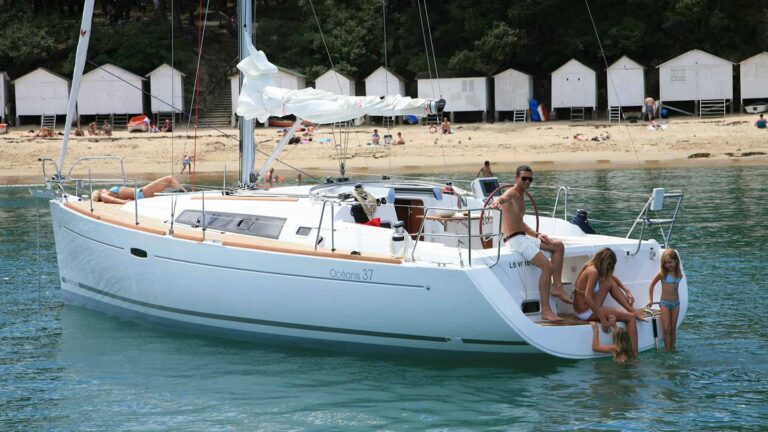 Family swimming off an anchored Beneteau Oceanis 37