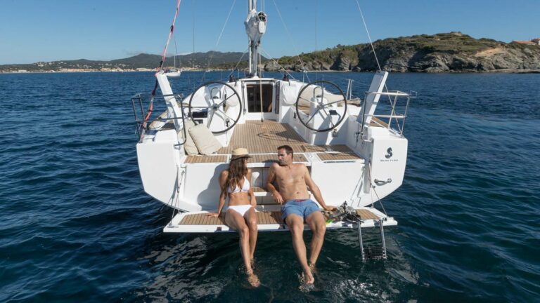 Couple relaxing off the stern of the Beneteau Oceanis 38.1 "Wright By The Sea"