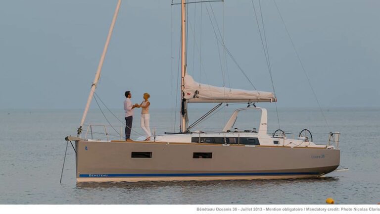 Couple dancing on the deck of an anchored Beneteau Oceanis 38
