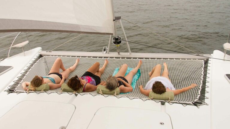 Family lounging on a trampoline on a Fountaine-Pajot Helia 44