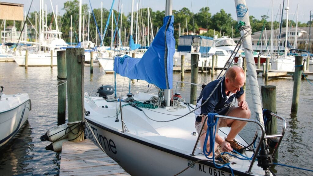 A sailboat awaits a crew to embark on its next journey into the Gulf. Situated at the Fairhope Docks, SailTime Alabama provides access to a fleet of sailboats, exclusively available to members who seek sailing experience.